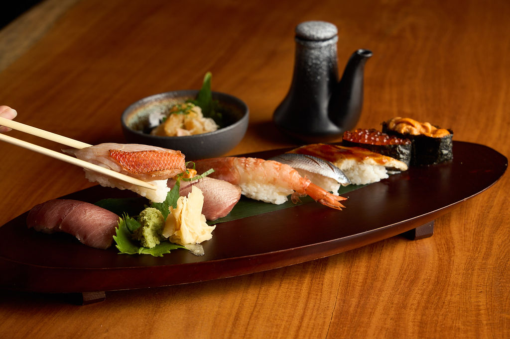 Anaba omakase — full nigiri spread with sake vessel and seasonal selections