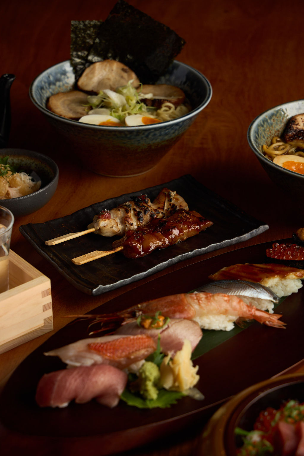 Anaba table spread — omakase, ramen, yakitori, and sake all together